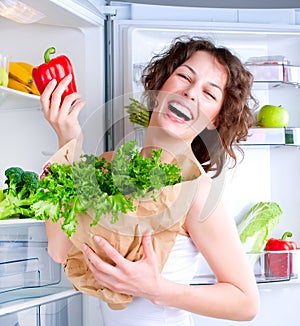 Diet.Young Woman near the Refrigerator