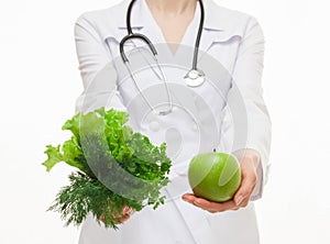 Dietarian proposing fresh greens and a green apple for you