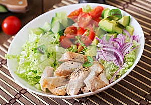 Dietary salad with chicken, avocado, cucumber, tomato