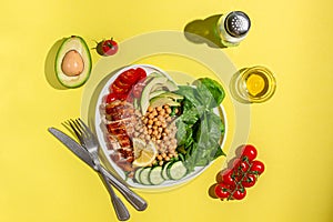 Dietary salad with chicken, avocado, cucumber, tomato and spinach