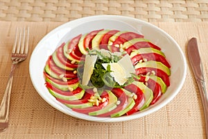 Dietary salad with zucchini, tomato, arugula and sliced parmesan