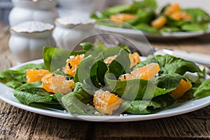 Dietary spinach salad and Mandarin oranges with lemon dressing and sesame seeds