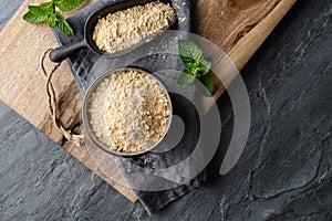 Dietary supplement, Maca root powder in a bowl and scoop with copy space