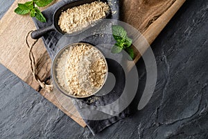 Dietary supplement, Maca root powder in a bowl and scoop with copy space photo