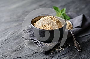 Dietary supplement, Maca root powder in a bowl and spoon with copy space
