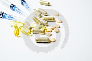 Dietary supplements pills and capsules and medical syringe