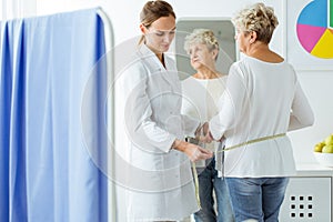 Dietician measuring patient`s body circuit