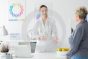 Dietician welcoming elderly client photo