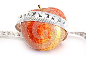 Dieting concept with apple and measuring tape