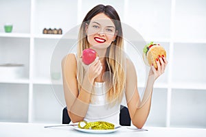 Dieting concept, beautiful young woman choosing between healthy