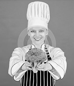Dieting concept. Eat healthy. Girl wear hat and apron hold vegetable. Healthy ration. Woman professional chef hold raw