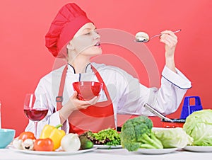 Dieting concept. Eat healthy. Healthy ration. Girl wear hat and apron try mushroom taste. Woman professional chef hold