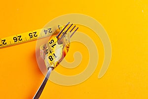 Dieting concept with fork and meter