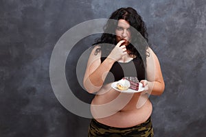 Dieting concept. Young obese overweight woman fighting the tempt