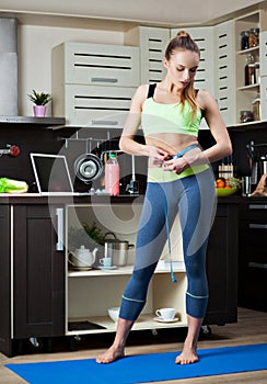 Dieting girl on her kitchen