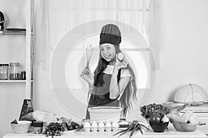 dieting. happy childhood. happy child wear cook uniform. chef girl in hat and apron. kid cooking food in kitchen