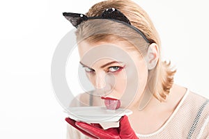 Dieting and health. Cat woman eat sour cream. Ecology product and heath. cat woman lick milk from plate. Food and