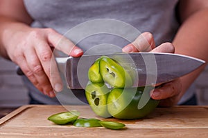 Dieting, healthy food, low carb diet. Hands slicing bell pepper,