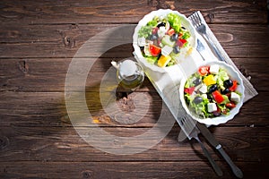 Dieting healthy salad on rustic wooden table top view