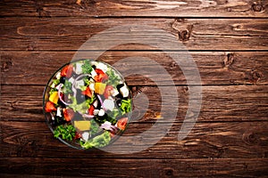 Dieting healthy salad on rustic wooden table top view