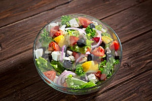 Dieting healthy salad on rustic wooden table top view