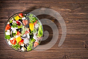 Dieting healthy salad on rustic wooden table top view