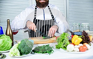 Dieting and organic food, vitamin. Bearded man cook in kitchen, culinary. Healthy food cooking. Chef man in hat. Secret