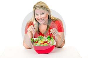 Dieting young woman with bowl of fresh salad
