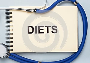 Diets word on cubes, dieting concept and doctor hands