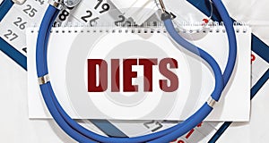 Diets word on cubes, dieting concept and doctor hands