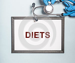 Diets word in doctor hands, dieting concept