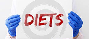 Diets word in doctor hands, dieting concept