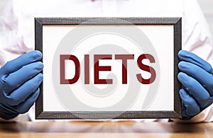 Diets word in doctor hands, dieting concept