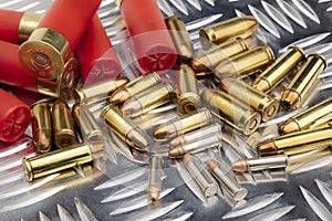 Difference of size of ammunition gun bullets on daimond plate background photo