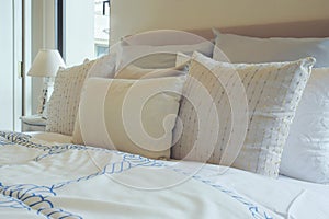 Difference size of white pillows setting on bed