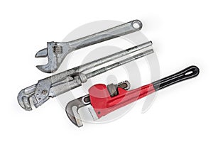 Different adjustable wrenches for plumbing work on a white background