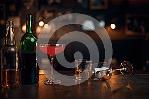 Different alcohol beverages on counter in bar