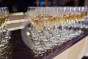 Different alcohol beverages in glasses on the table in restaurant or bar.