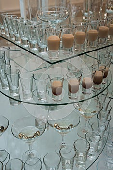 Different alcohol drinks on a glass stand. wine, champagne, cognac, vodka, martini