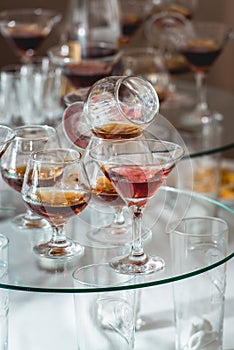 Different alcohol drinks on a glass stand. wine, champagne, cognac, vodka, martini