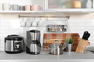 Different appliances, clean dishes and utensils