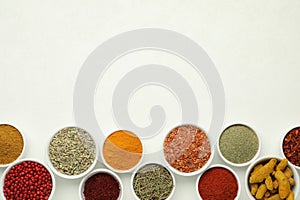 Different aromatic spices and herbs on white background, flat lay