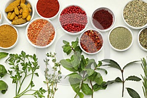 Different aromatic spices and herbs on white background, flat lay