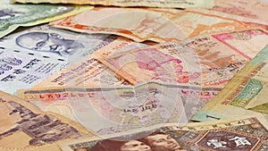 Different asian currency bank notes rotating business background