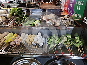 Different asian food skewers with vegetables and meat