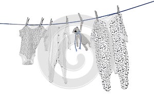 Different baby clothes and toy drying on laundry line against background