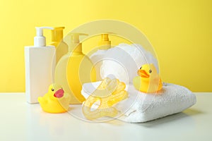 Different baby hygiene accessories against yellow background