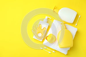 Different baby hygiene accessories on yellow background