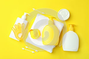 Different baby hygiene accessories on yellow background