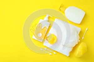 Different baby hygiene accessories on yellow background